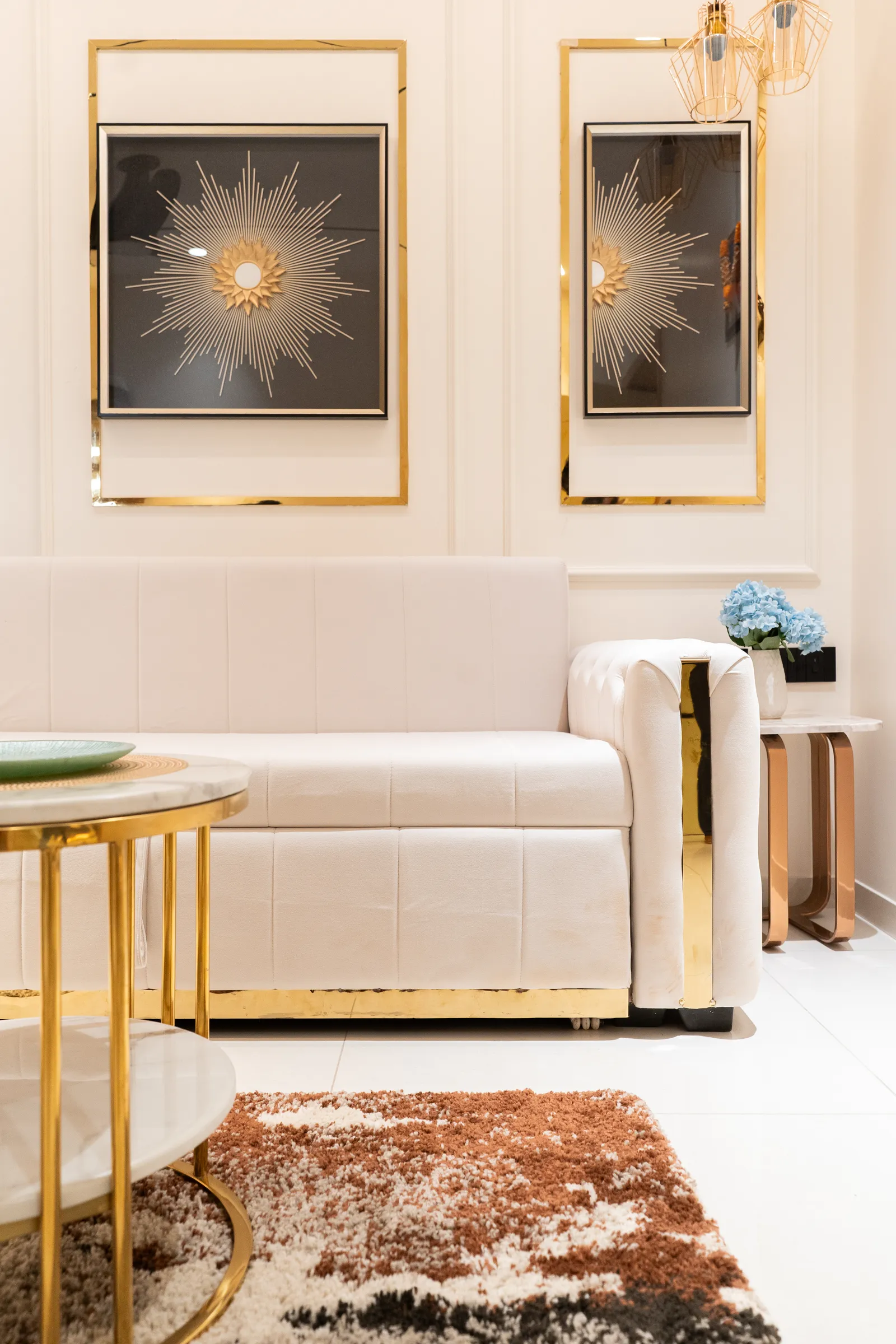 Tufted cream sofa with gold side table and shag rug — Abhishek's Residence